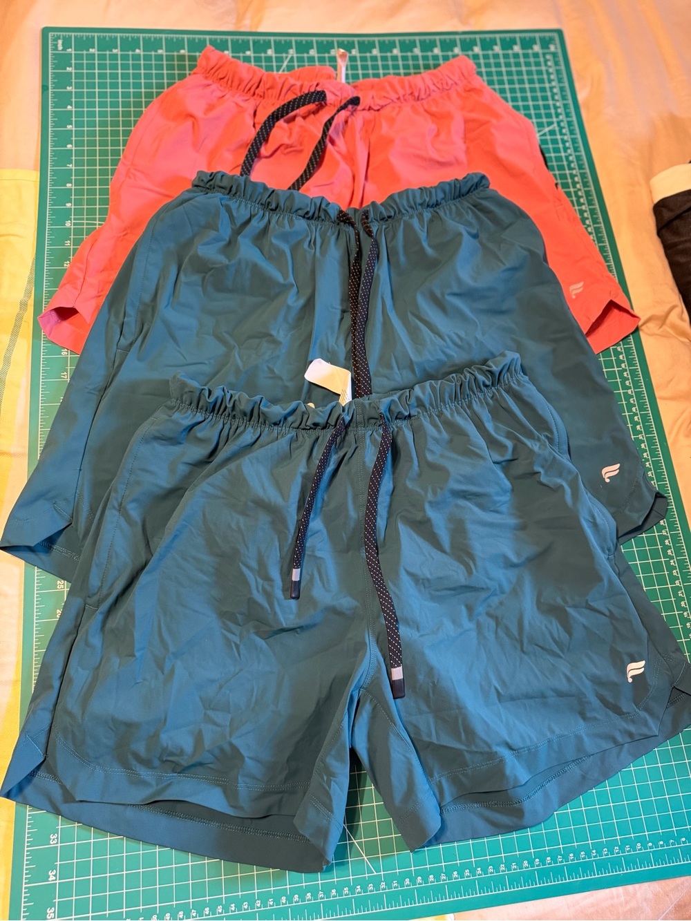 Fabletics Men’s “the one short” Teal and Coral Athletic Training Shorts.